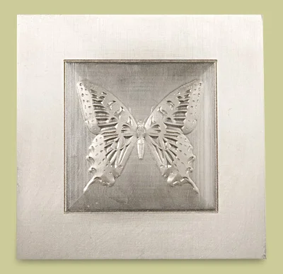 Sculptured emboss die of a butterfly in a recessed metal plate