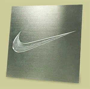 Emboss die with a curved swoosh shape